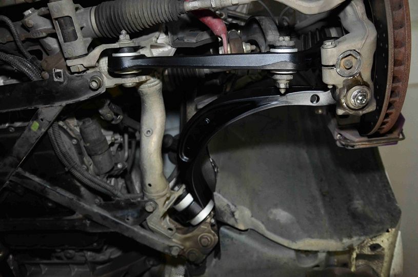 Close-up of a vehicle's suspension system with various components.