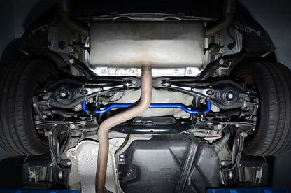 Close-up view of a car's undercarriage with visible suspension components and exhaust system.