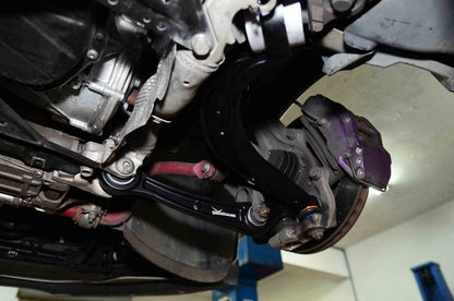 Close-up of a car's undercarriage with suspension components.