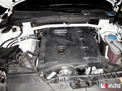Car engine compartment with Ultra Racing logo visible