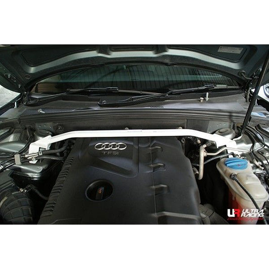 Car engine with a white strut bar on an Audi vehicle, featuring Ultra Racing branding.
